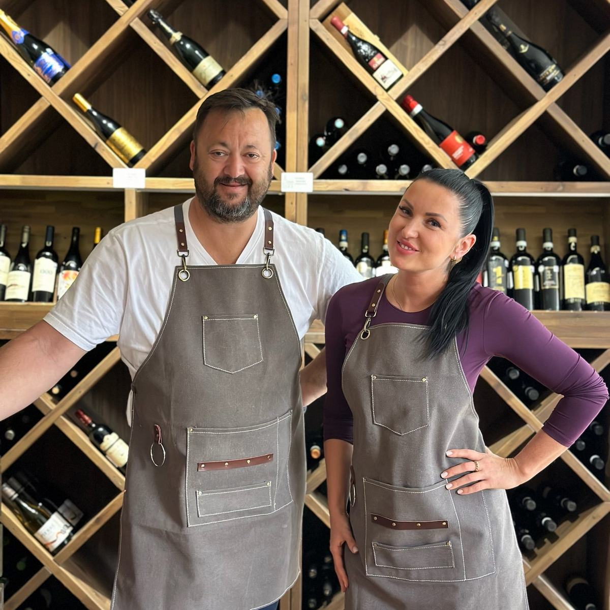 Hereford founders standing in steakhouse with wine selection background